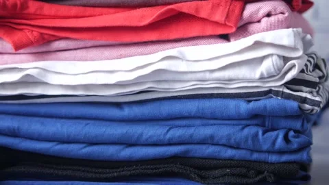 Close up of stack of clothes on table . Stock Footage 162745214