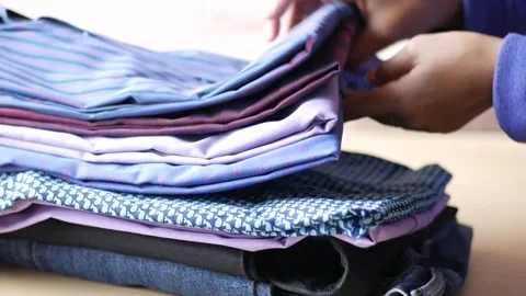 Close up of stack of clothes on table . Stock Footage 186106878