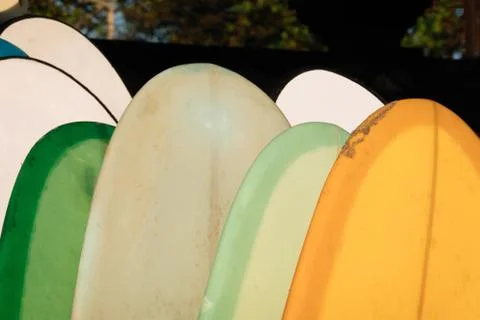 Close up Stack of colorful surfboards on beach background for rent. Travel Stockfoto's