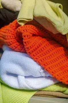 A close-up of a stack of colorful sweaters neatly folded on top of each other Stock Photos