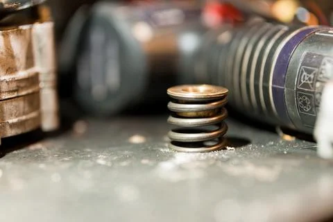 Close-up of a Stack of Compression Springs on a Workbench Surrounded by Tools Stock Photos