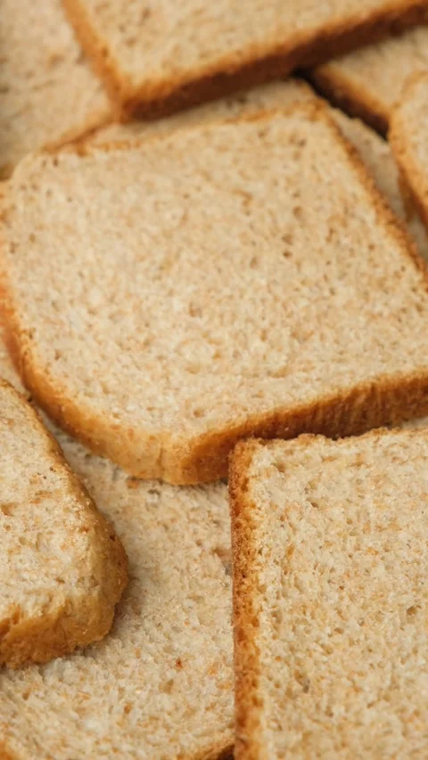 Close-up of a stack of crispy whole wheat toast bread slices rotating slowly. Stock Footage 336953001