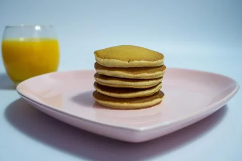 Close-up of stack of delicious fluffy pancakes with fresh strawberries and su Stock Photos