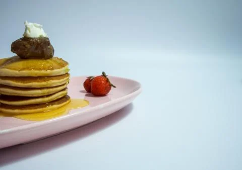 Close-up of stack of delicious fluffy pancakes with fresh strawberries and su Stock Photos