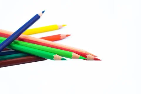 Close up of stack of different colored wood pencil crayon on a white backgrou Stock Photos