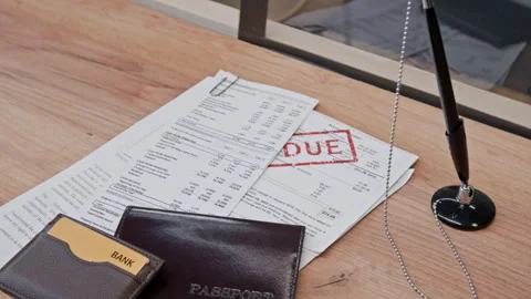 Close up of Stack of Documents and Passport on Bank Counter with Pen Stock Footage 330970856