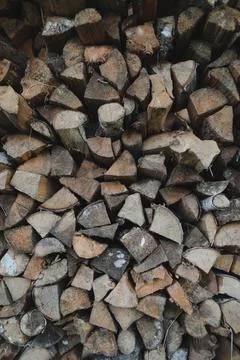 Close up stack of dry firewood oak wooden logs, chopped, split and organized in Stock Photos
