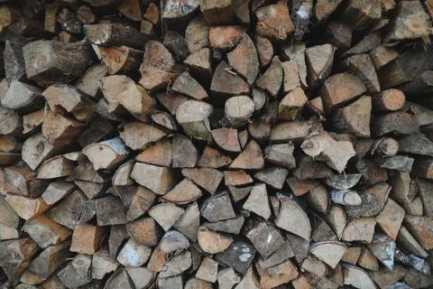 Close up stack of dry firewood oak wooden logs, chopped, split and organized in Stock Photos