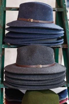 Close-up of stack of fashion female wool hats gray and blue colors. Stock Photos