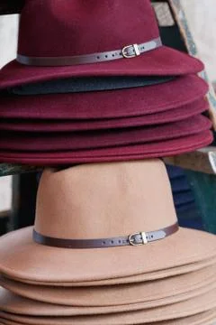 Close-up of stack of fashion female wool hats purple and beige colors. Stock Photos