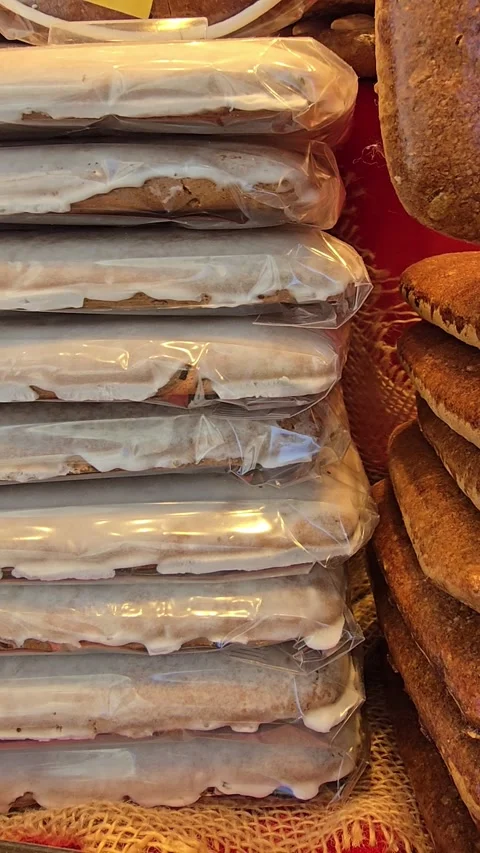 Close-up of a stack of fresh baked goods and gingerbread on a market display Stock Footage 341902729