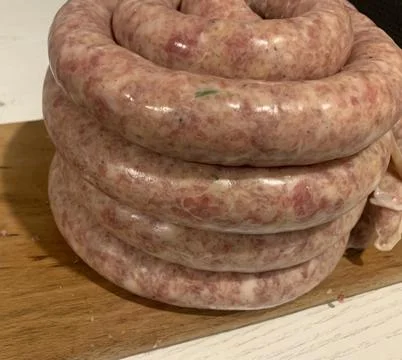 Close-up of a stack of fresh pork sausages cooked in the home kitchen Stock Photos