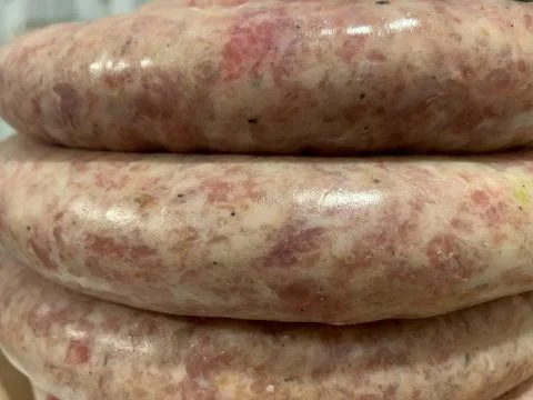 Close-up of a stack of fresh pork sausages cooked in the home kitchen Stock Photos