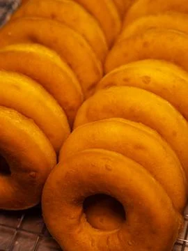 A close-up of a stack of freshly baked glazed donuts Stock Photos