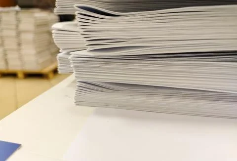 Close-up, a stack of glued book blocks prepared for binding in a printing hou 写真素材