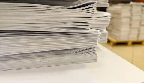 Close-up, a stack of glued book blocks prepared for binding in a printing hou Stock Photos