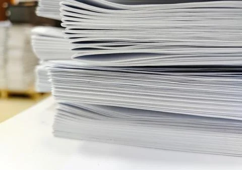 Close-up, a stack of glued book blocks prepared for binding in a printing hou Stock Photos