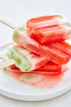 Close-up of a stack of melting homemade berry ice cream in a bowl with spills on Stock Photos