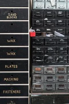 Close up of stack of metal drawers containing selection of hardware for metal 스톡 사진