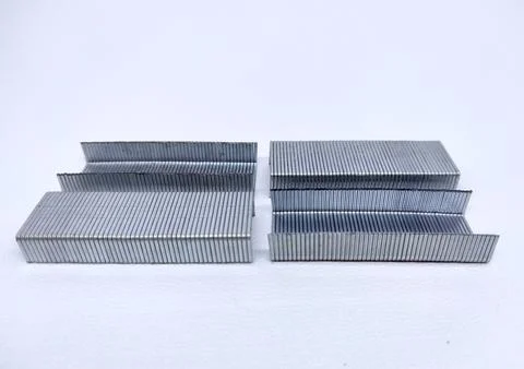 Close up of stack of metal staples for stapler gun isolated in white backgrou Stock Photos