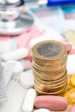 Close up of a stack of money with capsules in the background Stock Photos