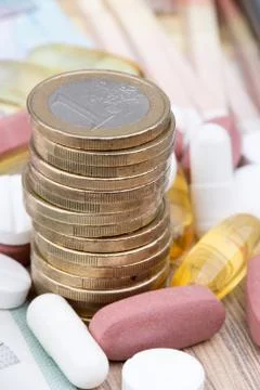 Close up of a stack of money with capsules in the background Stock Photos