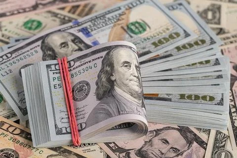 Close Up Stack of New One Hundred US Dollar Bills on Scattered Money Backgrou Stock Photos