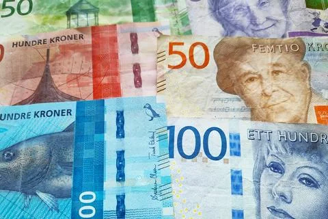 Close-up on a stack of Norwegian krone and Swedish Krona. Stock Photos