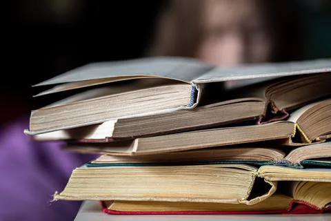 Close-up of a stack of open books on a blurred background. 写真素材