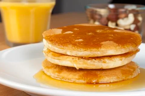 Close up of a stack of pancakes covered in syrup Stock Photos