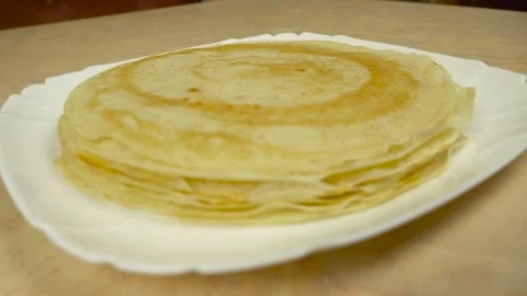 Close-up of a stack of pancakes on plates, standing on the table. Stock Footage 136487568