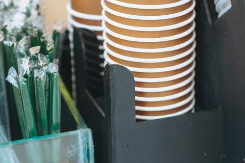 Close up of stack of paper cups and green straws Stock Photos