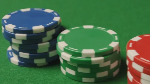 A close-up stack of poker chips, man's hand doing a bet, chips sliding Stock Footage 125983030