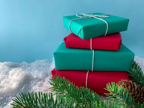 Close up stack of simple christmas present on snow with copy space. Stock Photos