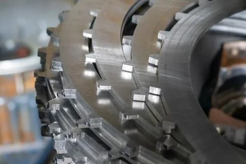 Close up stack of steel clutch plates rests on workbench inside transmissio.. Stock Photos