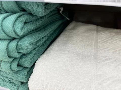 Close up of stack of towels on shelf in store. Stock Photos