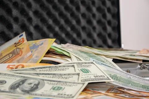 Close-up of a stack of US dollar and euro bills in a case Stock Photos
