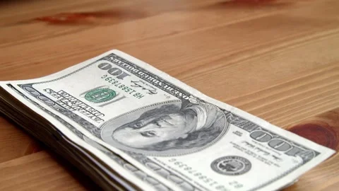 Close Up Stack Of US Dollar Bills Falling On Table In Slow Motion Stock Footage 326171591