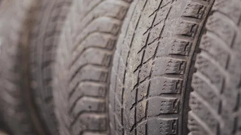 Close up of a stack of used car tire treads showing wear and patterns Stock Photos