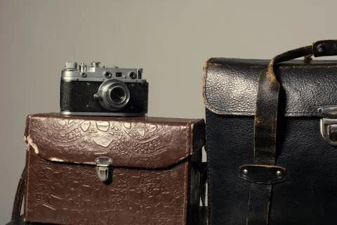 Close-up of a stack vintage shabby suitcases and camera Stock Photos