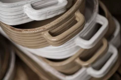 Close Up of Stack of White and Tan-colored Baking Dishes Stock Photos