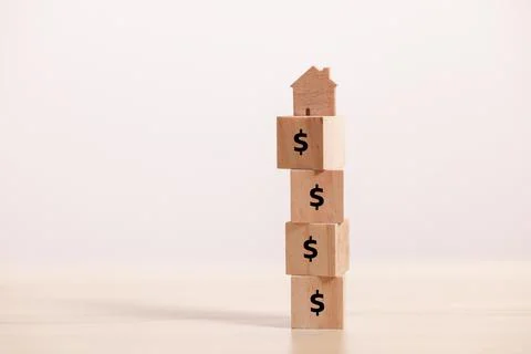 Close up stack Wooden home icon on stack block with dollar icon. business con Stock Photos