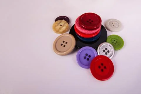Close up stacked buttons multi colored and different sizes Stock Photos
