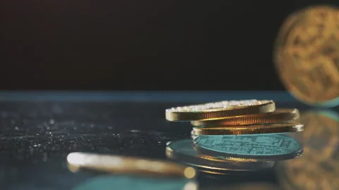 Close-up of stacked cryptocurrency coins on a reflective surface Stockbeeldmateriaal 328286436