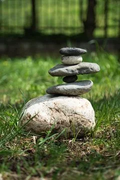 Close-up of stacked pebbles in forest . Vertical shot Stock Photos
