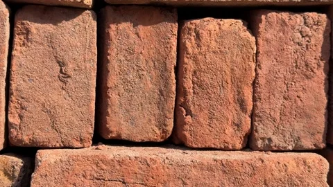 Close-up of stacked red bricks forming a textured wall background with natu.. Stock Footage 330800825