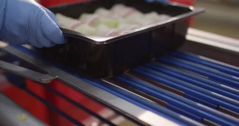 Close up of stacked red plastic crates with a person in blue protective Vídeo Stock 339973857