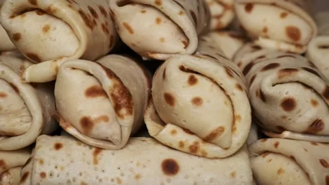 Close-Up of Stacked Rolled Pancakes Video stock 303858471