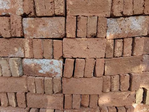 Close-up of stacked rustic red clay bricks texture background. Stock Photos