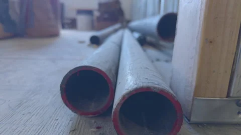 Close-up of stacked sections of CISPI (Cast Iron Soil Pipe) drain pipes Vidéo 330668423